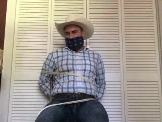 View Cowboy Gagged and Tied to a Kitchen Chair